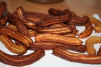 Transfer churros to a kitchen paper towel for a...