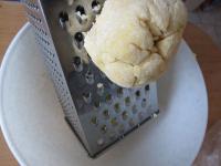 Grate the dough on a coarse grater into tiny tough...