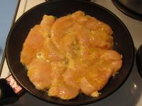 Fry the chicken breast with marinade in a dry hot...