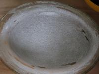 Grease an oval baking dish with butter and...