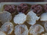 Tuck finished burgers into the cut buns brushed...