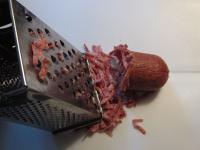 Coarsely grate salami....