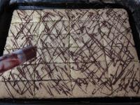 Using a syringe, gently decorate the cake with...