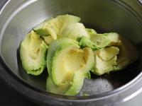 Peel a soft avocado, remove the stones and crush...