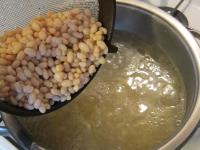 Add drained, sterilized beans to the cooked meat....