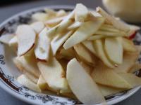 Peel the apples and cut them into thin halfmoon...
