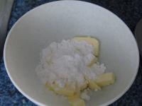 Use a wooden spoon to stir butter with sugar. ...