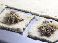 Use a rolling pin to spread the dough on floured...
