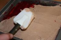 Half of the cream spread over the sponge fingers...