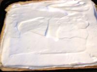 Spread egg whites foam onto the stiff cream cheese...