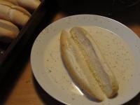 Cut the bread rolls along the length the way they...