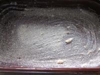 Grease a deep baking dish and sprinkle with...