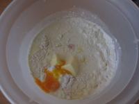 Pour flour in a bowl, add egg yolks, softened...
