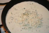 When the cheese melts, grate the blue cheese...