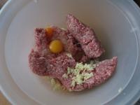 Add meat, raw eggs, salt and peeled pressed...