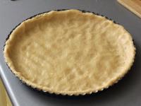Gradually press the dough into the pan cake....