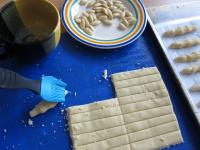 Brush end of the finger with beaten egg white and...
