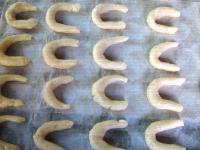 Work the dough and form small crescents from the...