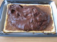 Once the cake has soaked up the liqueur, spread...