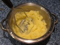 Crush potatoes, in water where it was cooked, into...