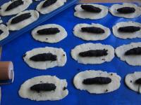 Evenly divide poppy seed filling over the prepared...