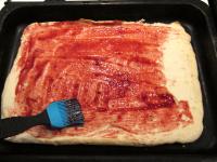 Remove parchment paper from finished cake base and...