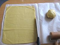 Split the dough into halves. Use a rolling pin to...