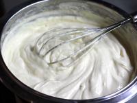 Beat egg yolks with sugar over a hot water bath,...