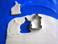 Use a rolling pin to spread the dough until it is...