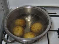 Cook four pieces of medium-size potatoes in water...