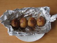 Remove baked potatoes from oven....
