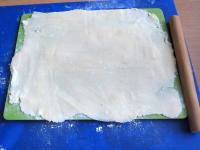 On a board sprinkled with cornstarch, roll the...