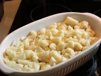 Spread the pieces of cauliflower on a greased...