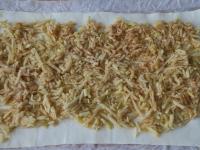 Unroll the dough rolled on paper. Spread lightly...