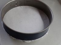 Line the round mold with baking paper or spread it...