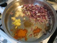 Add garlic, ginger and spices to the onion. Let it...