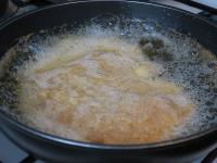 Put the schnitzel in the hot oil so that it is...