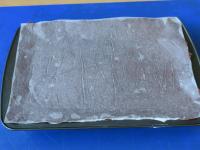 Transfer the dough on paper on the filling (paper...