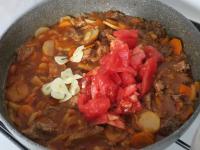 Add tomatoes, garlic, water ......
