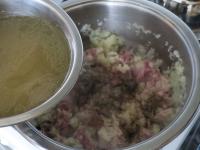 Add salt, season and pour broth or water....