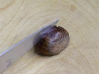Cut each chestnut through the peel on the round...