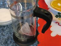 Pour hot water over the fruit tea and let it...