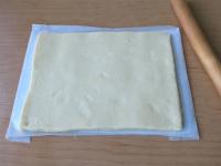 Roll the coconut dough on baking paper to a size...