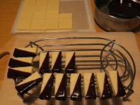 Dip the chopped bars in chocolate and place them...