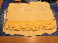 Unroll the puff pastry on baking paper and roll it...
