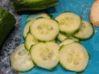 Wash the cucumber, cut it into thin wheels and...
