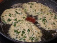 Heat the oil in a pan and create pancakes from the...