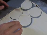 Unroll the puff pastry rolled on baking paper, put...
