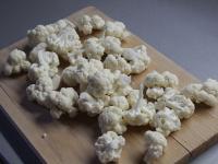 Wash the cauliflower and divide it into small...