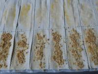 Spread the dough with whipped egg, sprinkle 8...